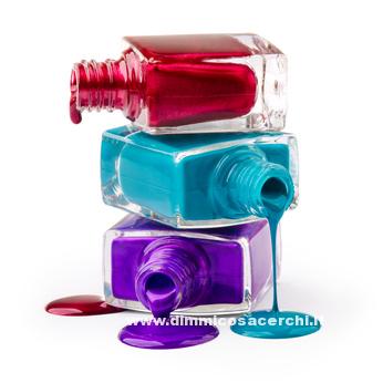 Bottles with spilled nail polish over white background